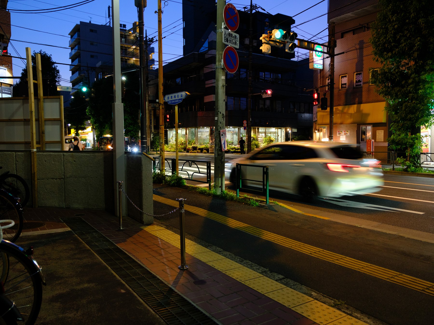 A Tokyo street with moving traffic photographed on Fujifilm at night