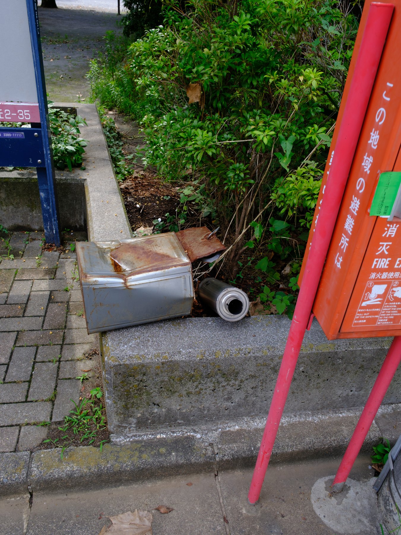 A red Japanese street fixture beside greenery, ready for a Fujifilm preset workflow