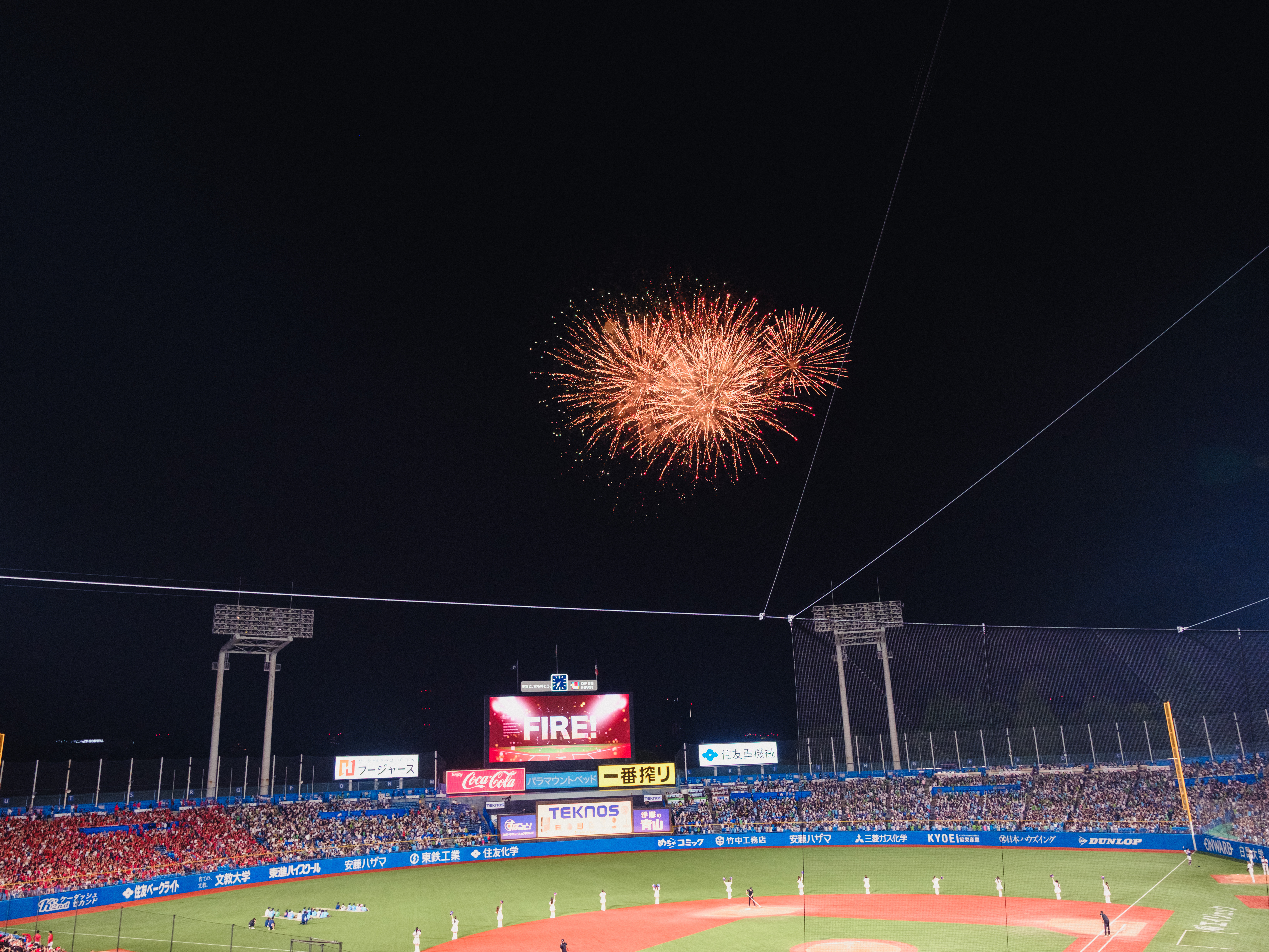 Summer fireworks above a Tokyo baseball stadium as a seasonal event beyond postcard subjects